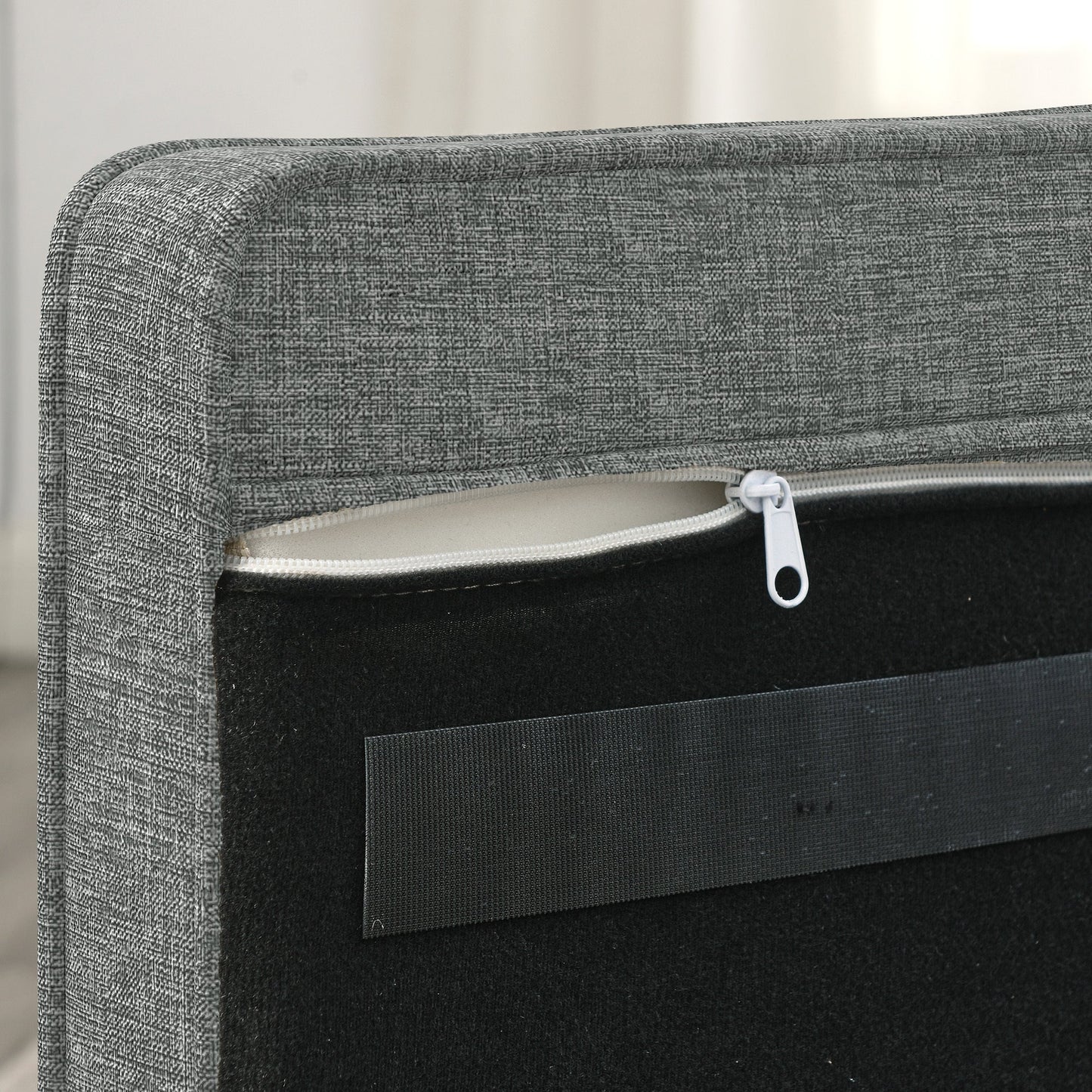 Gray upholstered headboard with a zipper detail