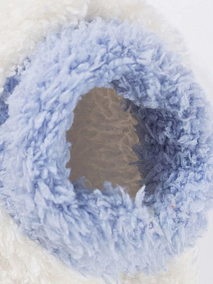 Close-up of a blue yarn ball with a white background