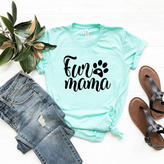 Mint green t-shirt with 'Fur Mama' text and paw print, paired with jeans and sandals on a white background.