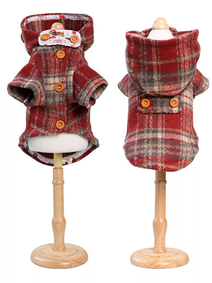 Two red plaid dog coats on mannequins against a white background
