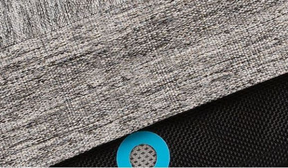 Close-up of a textured gray fabric with a blue circular object on a black background