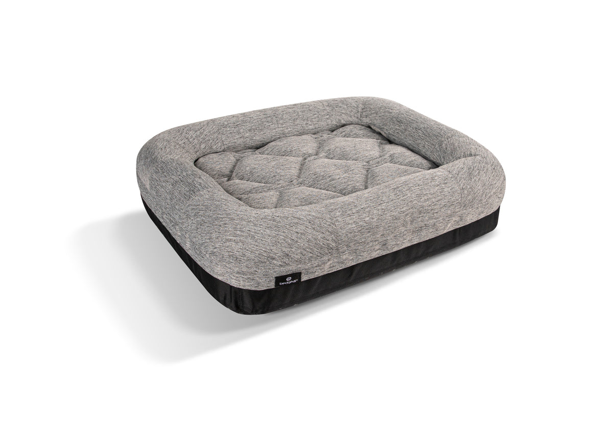 Gray pet bed with a textured surface on a white background
