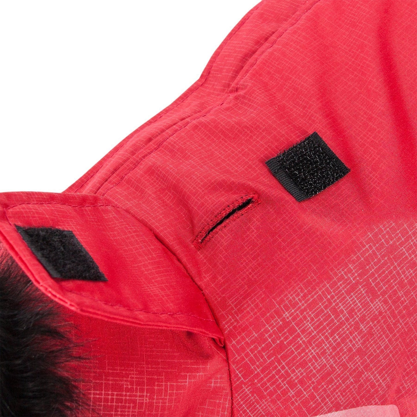 Close-up of a red jacket with a black patch on a white background