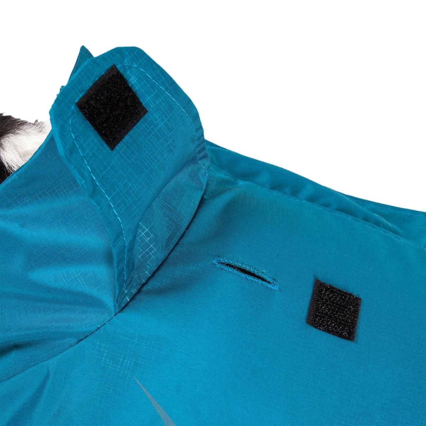Close-up of a blue jacket with black patches on a white background