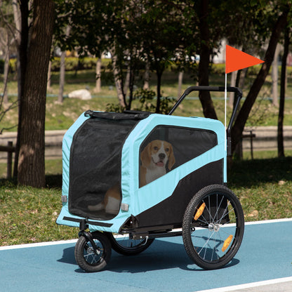 Pet stroller with a dog inside, parked on a path in a park.