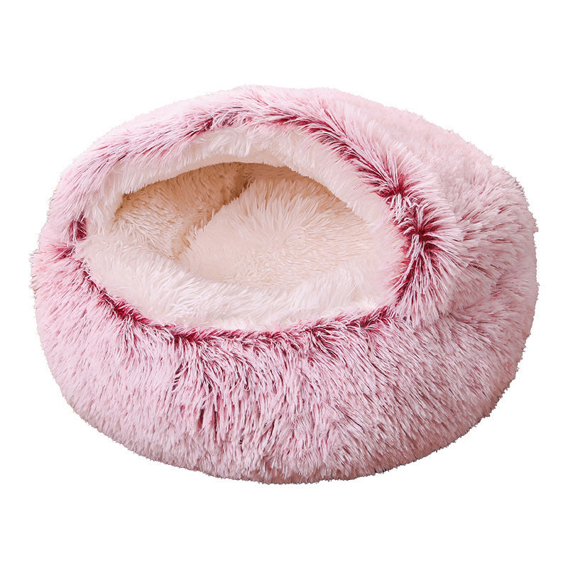 Pink fluffy pet bed on a white background