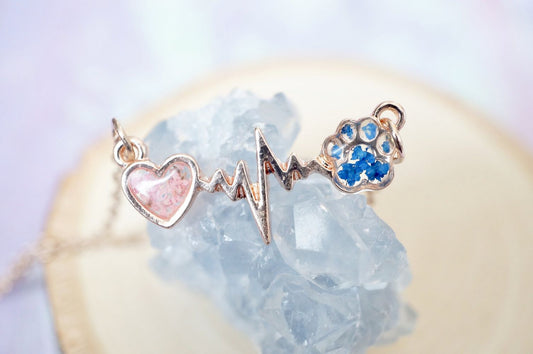 Jewelry set with heart, heartbeat symbol, and paw print on a crystal background