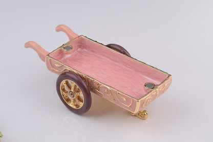 Decorative miniature cart with pink tray on a white background