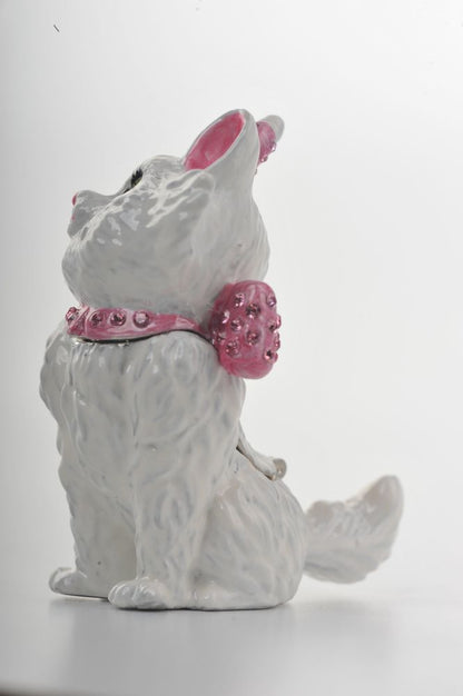 White ceramic dog figurine with pink embellishments on a white background