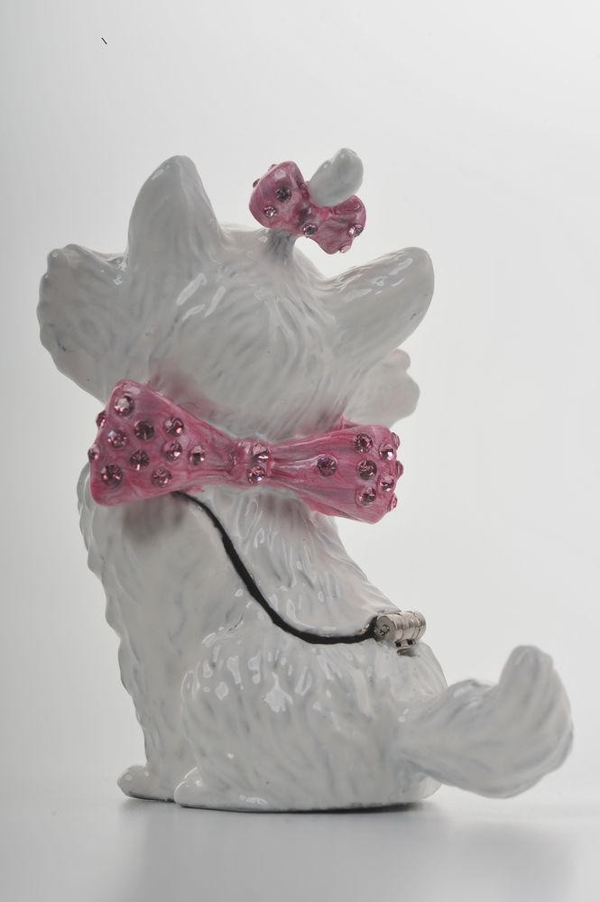 White ceramic dog figurine with pink decorative bow and flowers on a white background