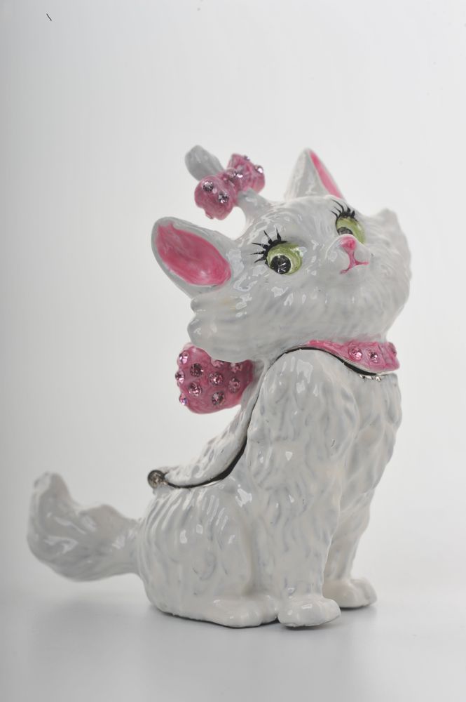 Decorative cat figurine with pink accessories on a white background
