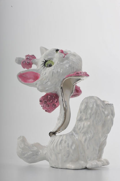 White ceramic dog figurine with pink accents and a hat on a white background