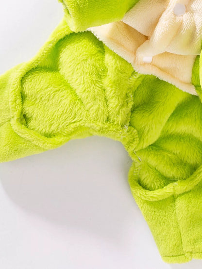 Close-up of a green plush toy with heart patterns on a white background