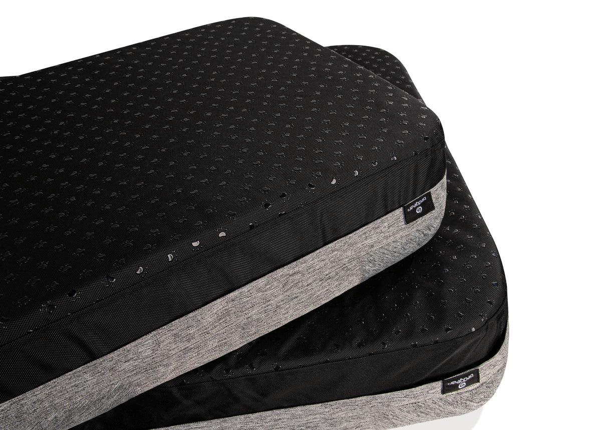 Black and gray mattress topper with brand label on a white background