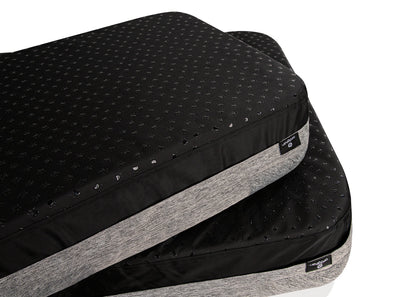 Black and gray mattress topper with brand label on a white background