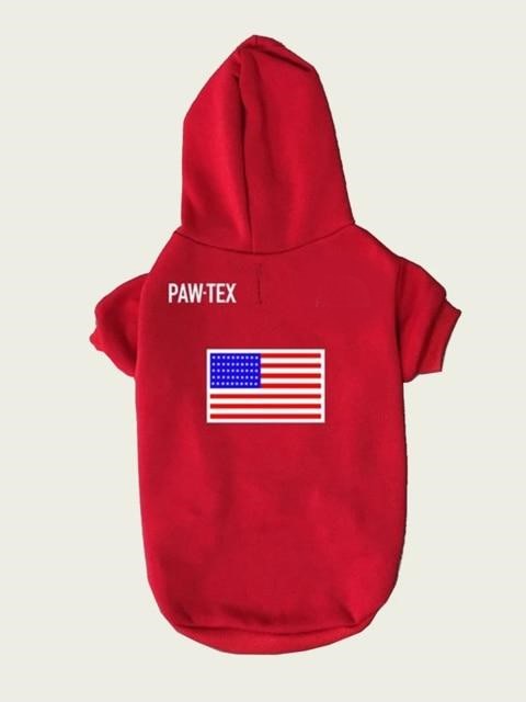 Red pet hoodie with American flag and 'PAW-TEX' branding on a beige background