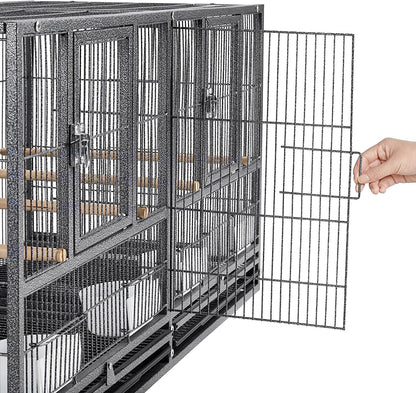 Large metal bird cage with a hand opening one of the doors on a white background