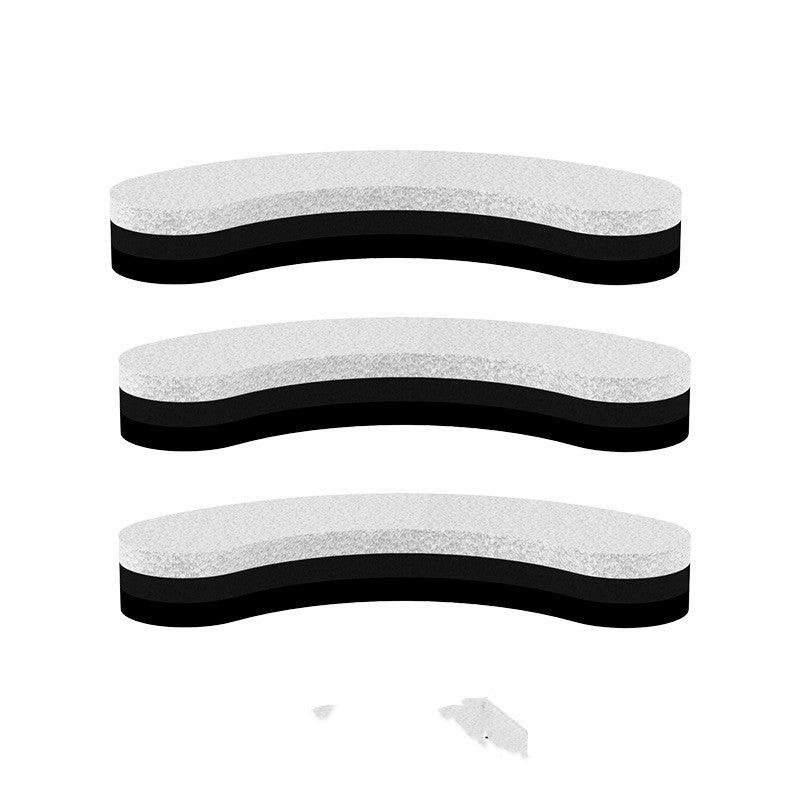 Three black and white shoe inserts on a white background