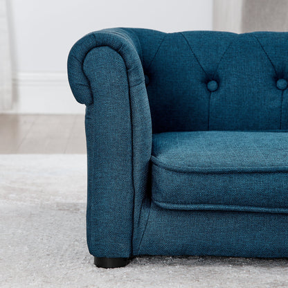 Blue upholstered chair with tufted backrest on a light gray carpet