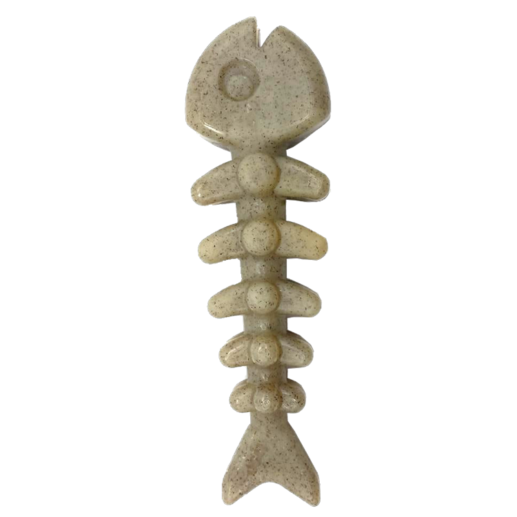 Beige fishing lure shaped like a fish skeleton on a white background