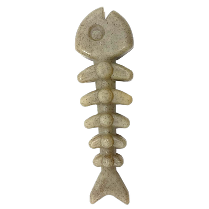 Beige fishing lure shaped like a fish skeleton on a white background