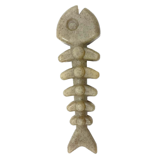 Beige fishing lure shaped like a fish skeleton on a white background