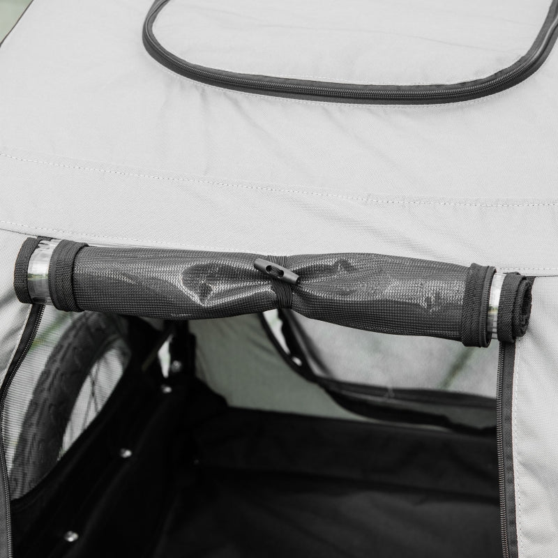 Close-up of a mesh screen on a vehicle's side window with a blurred background.