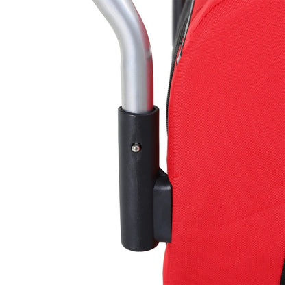 Close-up of a red folding chair with a black armrest and silver handle on a white background.
