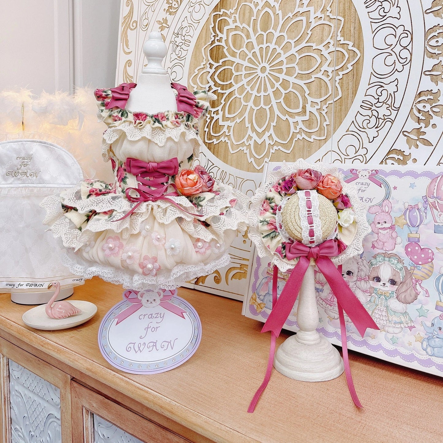 Decorative items on a wooden surface with a decorative wall in the background