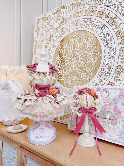 Decorative items on a table with a decorative wall panel in the background