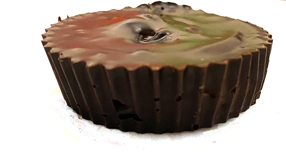 Chocolate cupcake with camouflage frosting on a white background