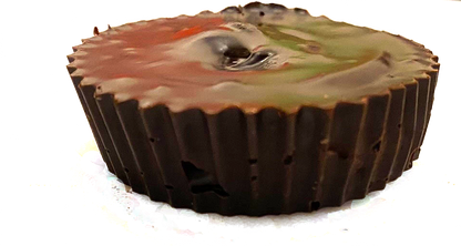 Chocolate cupcake with camouflage frosting on a white background