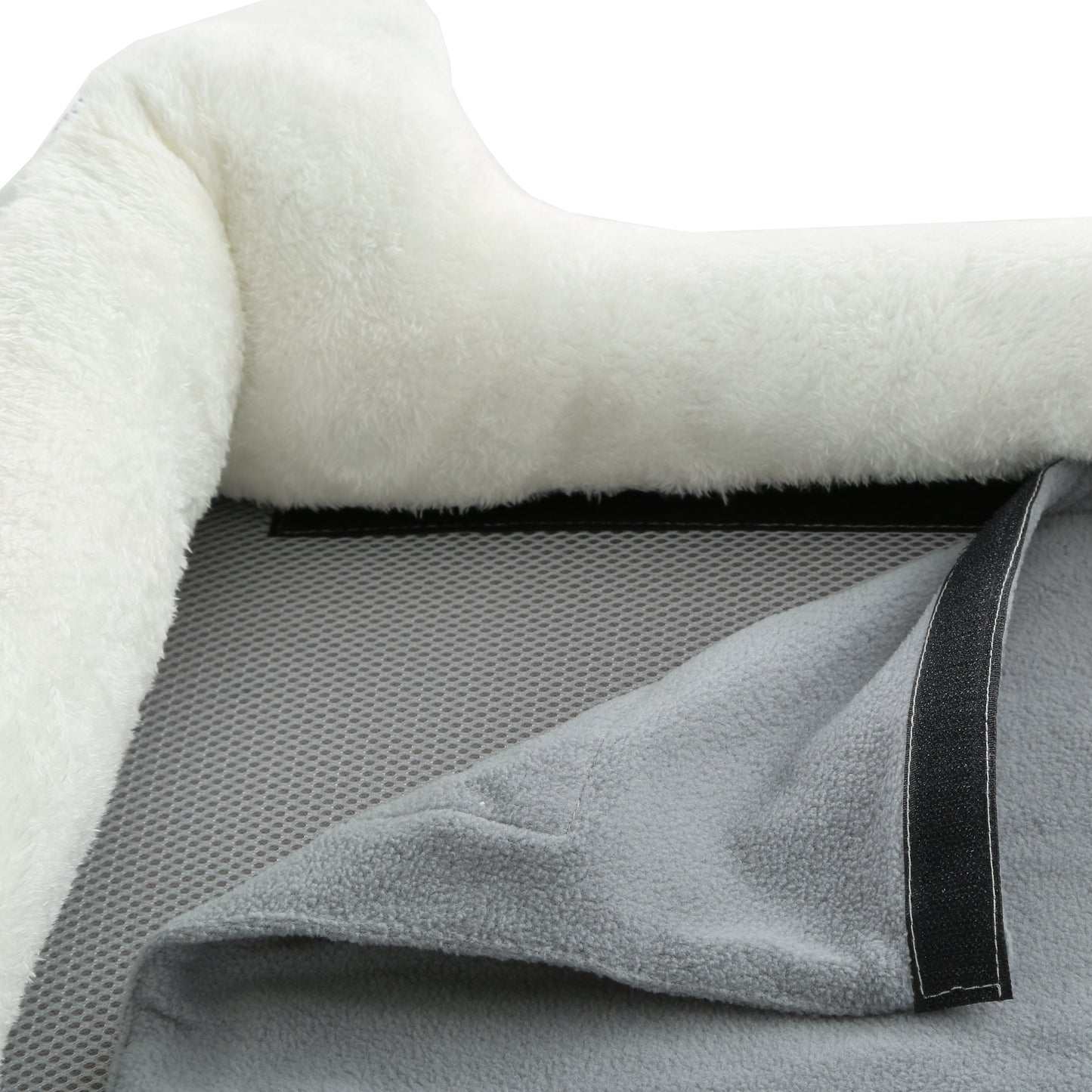 Close-up of a textured blanket with a soft white surface and gray mesh backing.