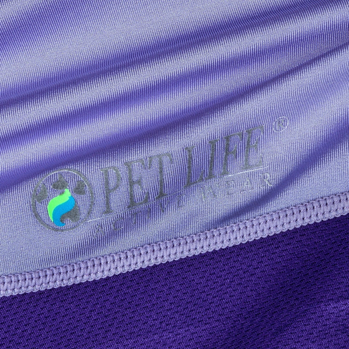 Close-up of purple fabric with 'PET LIFE' logo and text.