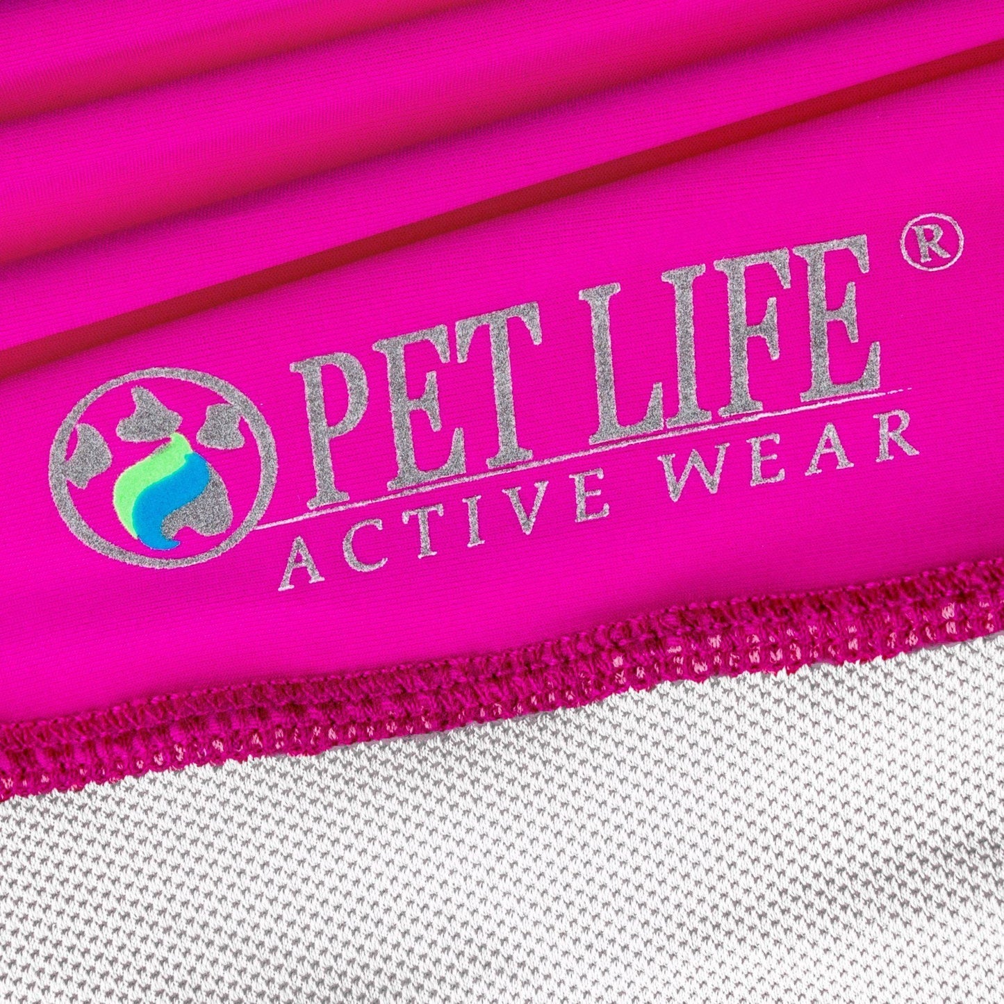 Close-up of pink pet clothing with 'Pet Life Active Wear' logo.