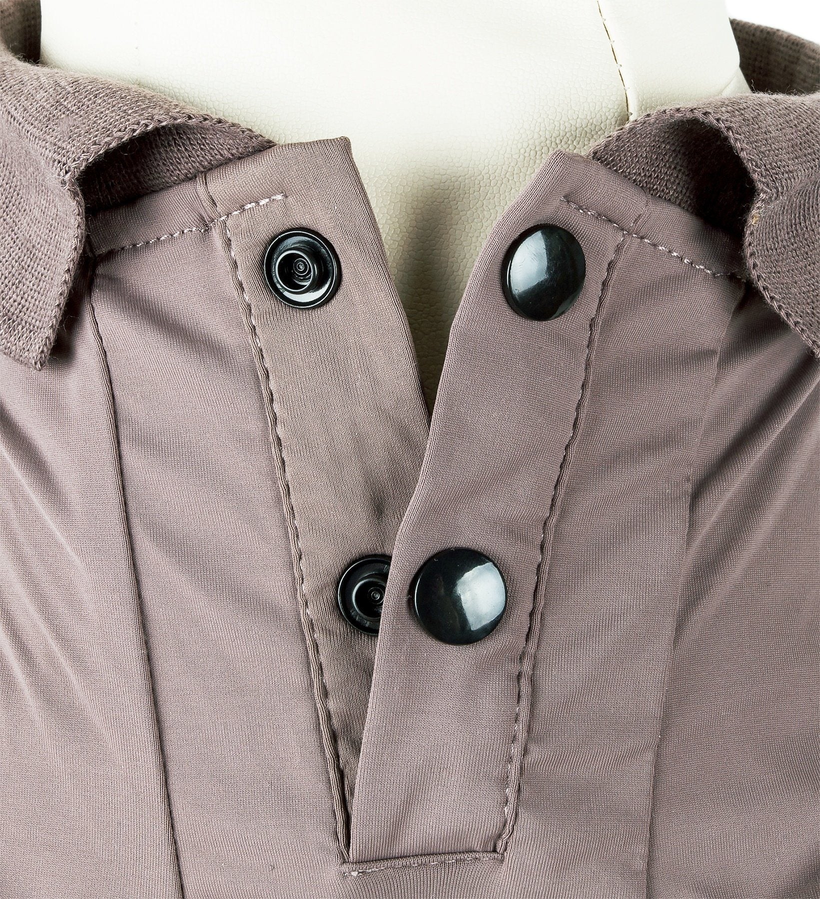 Close-up of a brown jacket with buttons on a neutral background