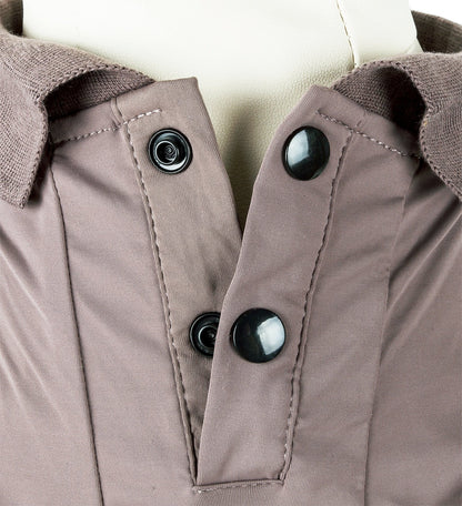 Close-up of a brown jacket with buttons on a neutral background