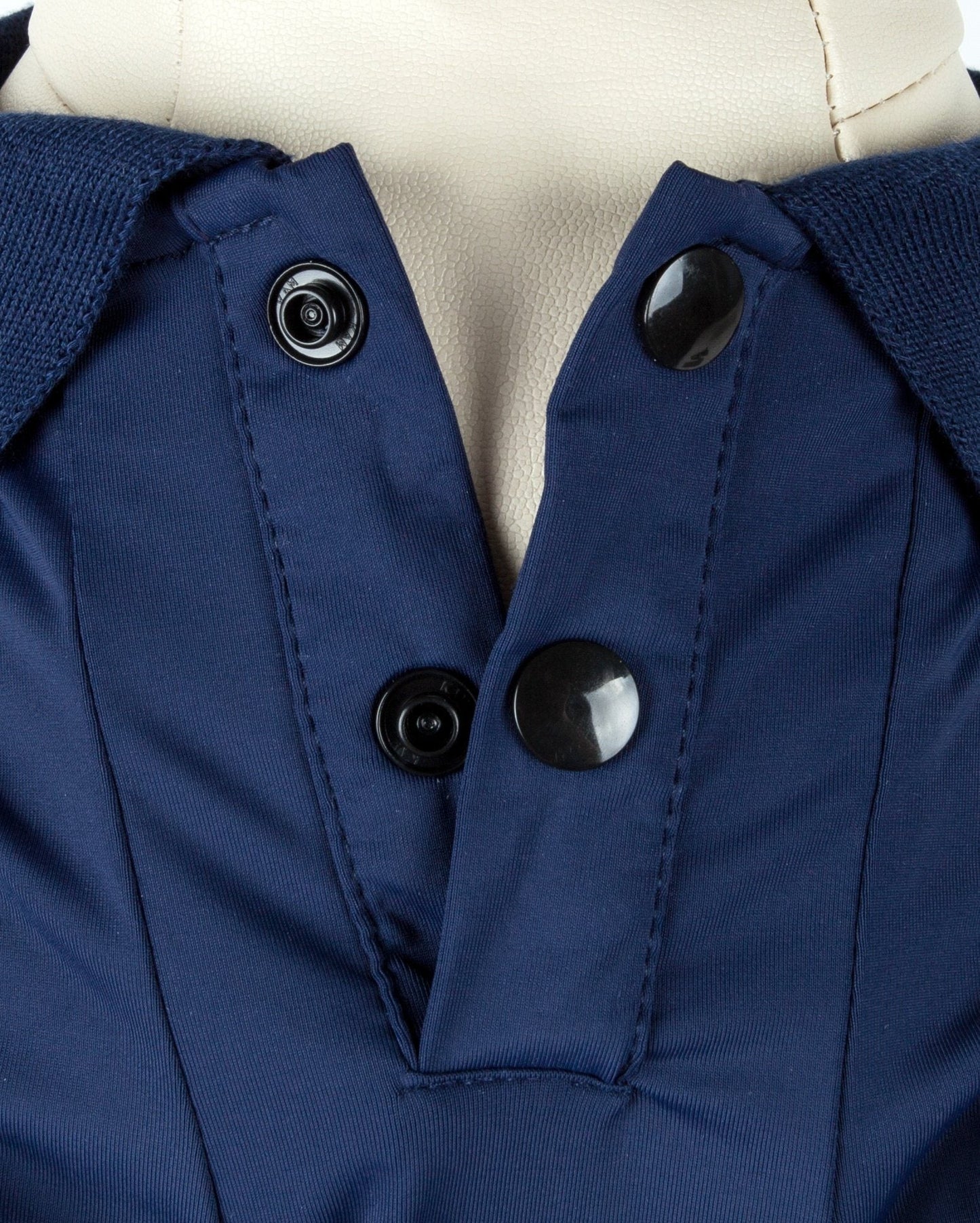 Close-up of a blue coat with black buttons on a mannequin