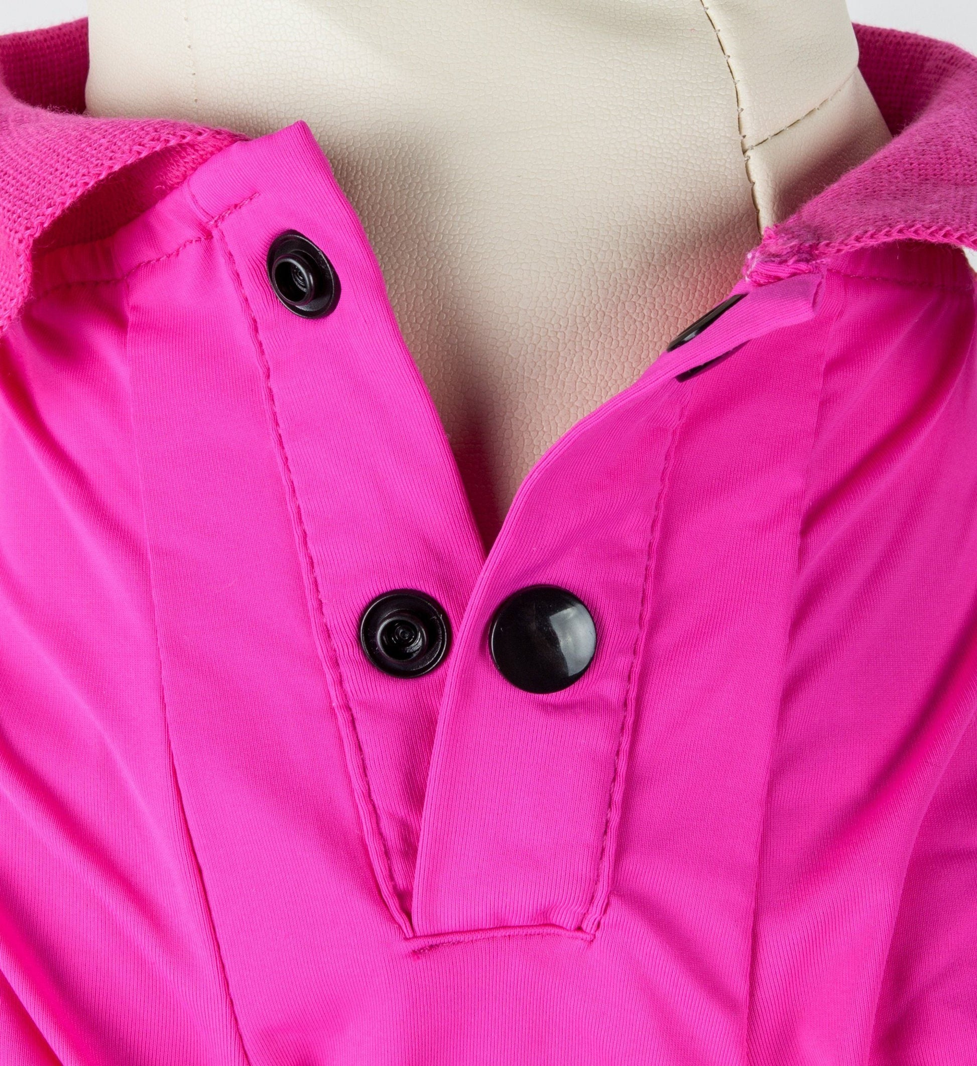 Close-up of a bright pink jacket with black buttons on a mannequin.