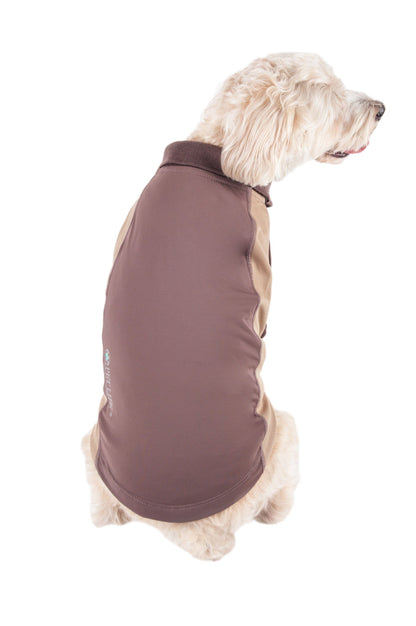 Dog wearing a brown fleece vest on a white background