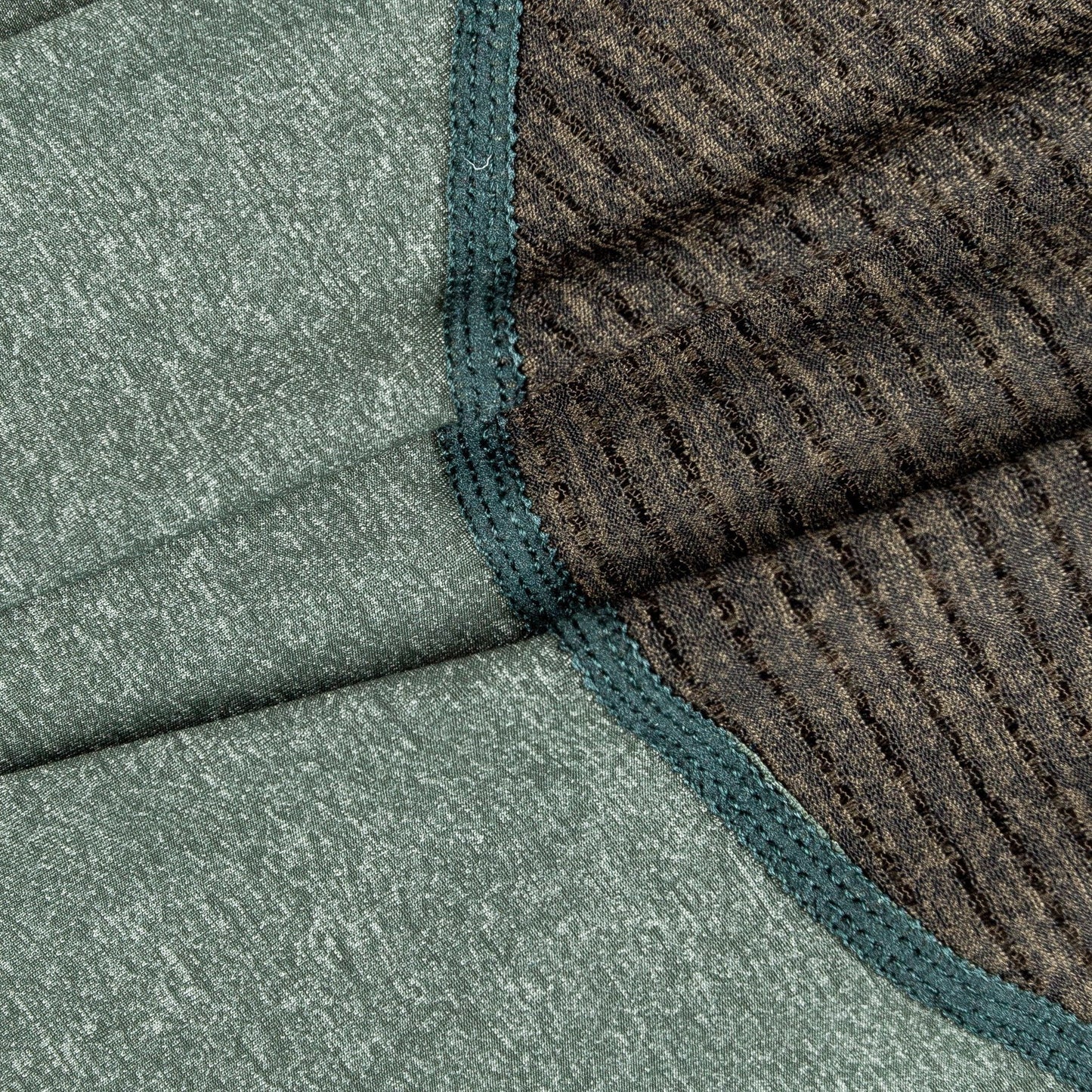Close-up of textured green and brown fabric with a geometric pattern