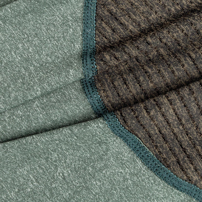 Close-up of textured green and brown fabric with a geometric pattern