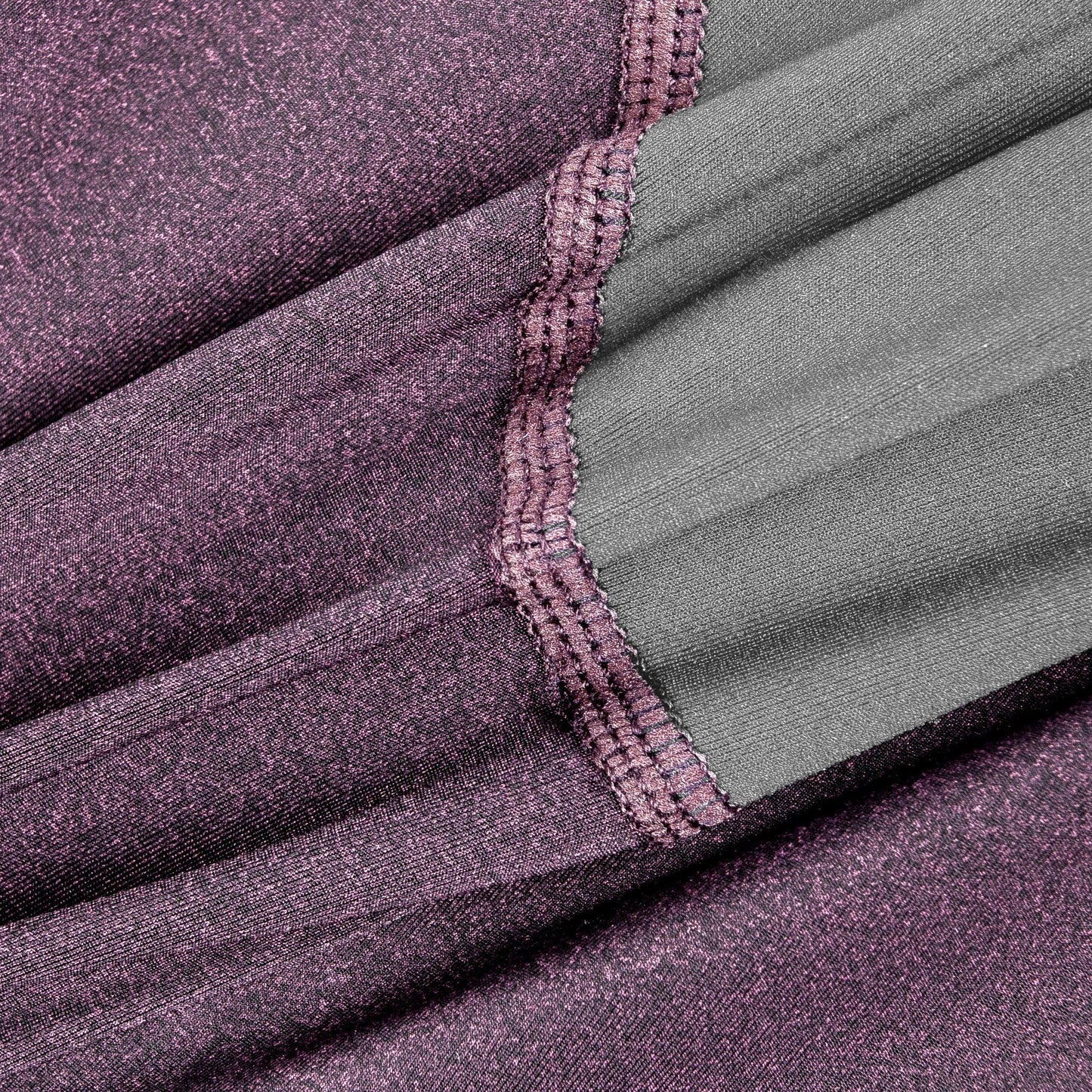 Close-up of purple fabric with a textured pattern and green lining.