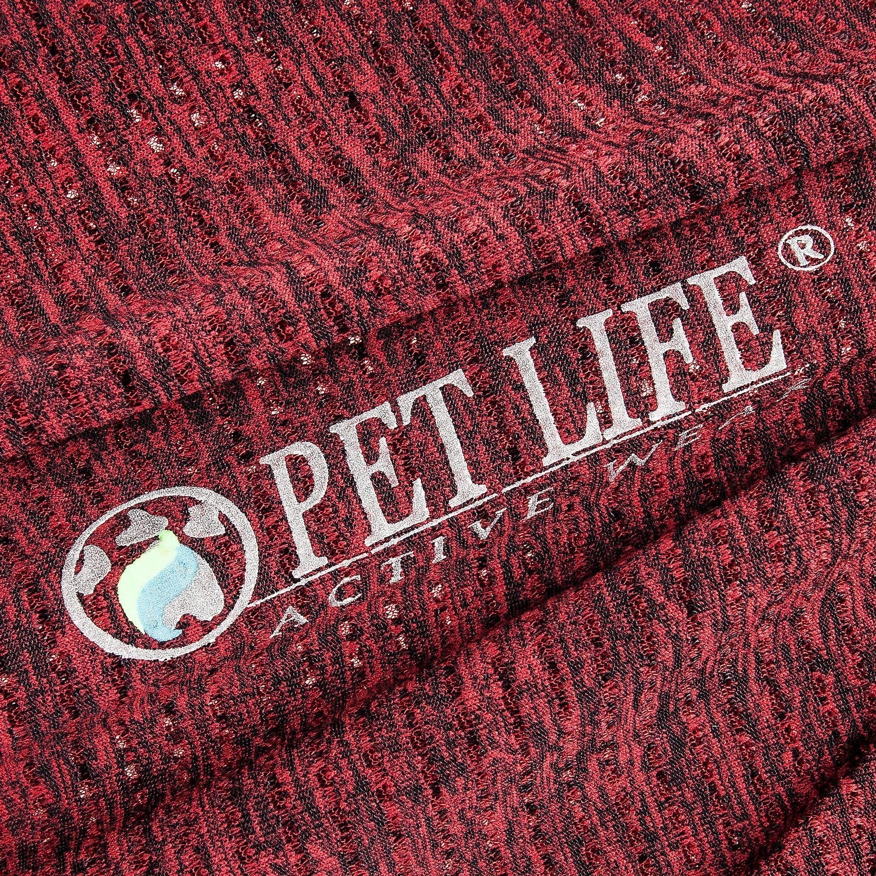 Close-up of red fabric with 'Pet Life Active' logo.