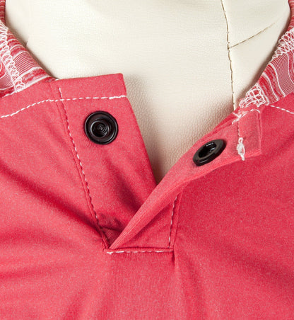 Close-up of a red garment with buttons on a white background