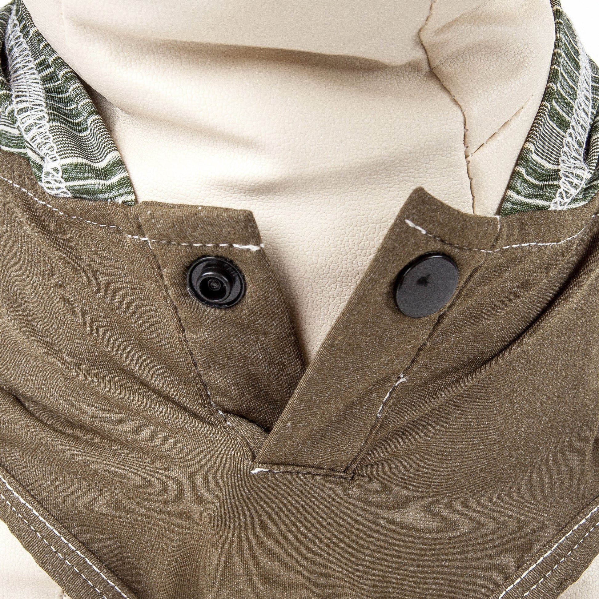Close-up of a brown jacket with buttons and a patterned lining.