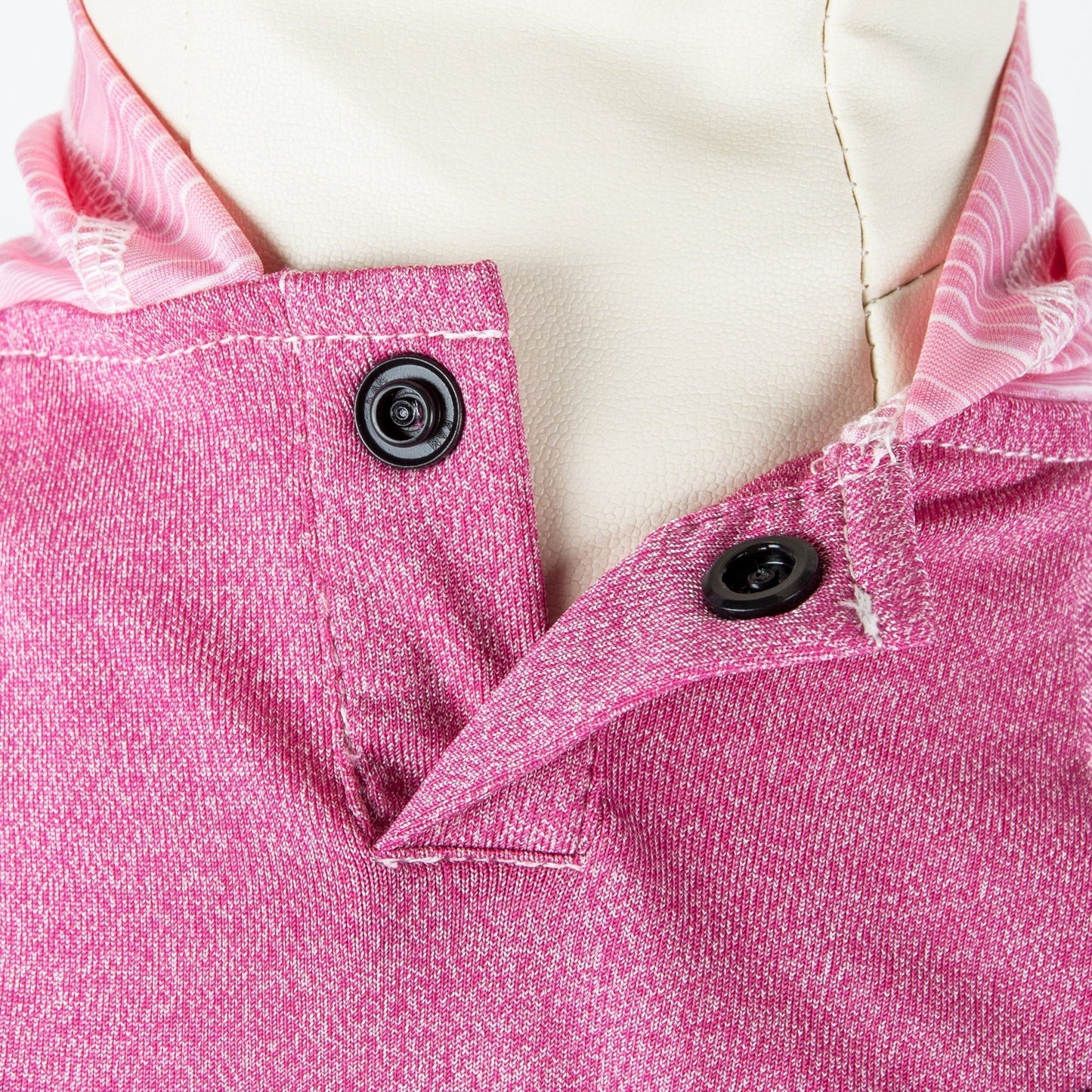 Close-up of a pink garment with buttons on a mannequin