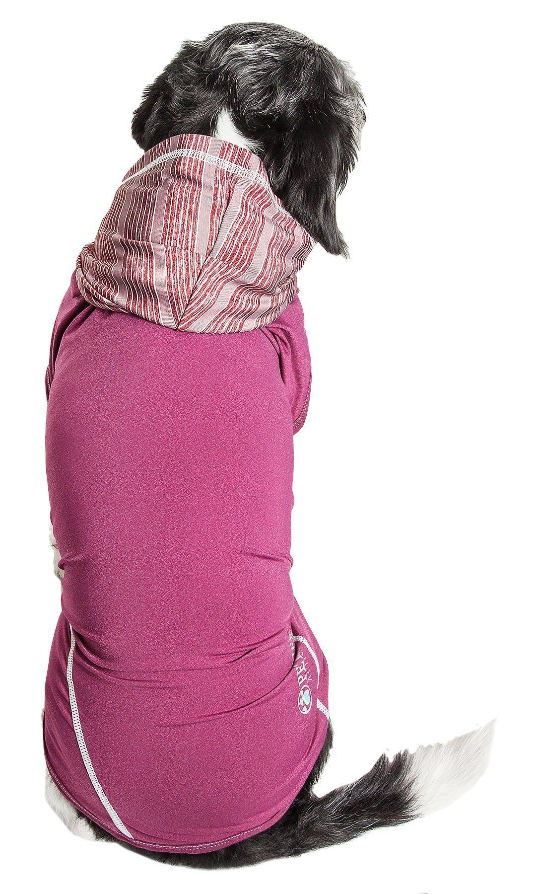 Dog wearing a pink coat with a hood on a white background