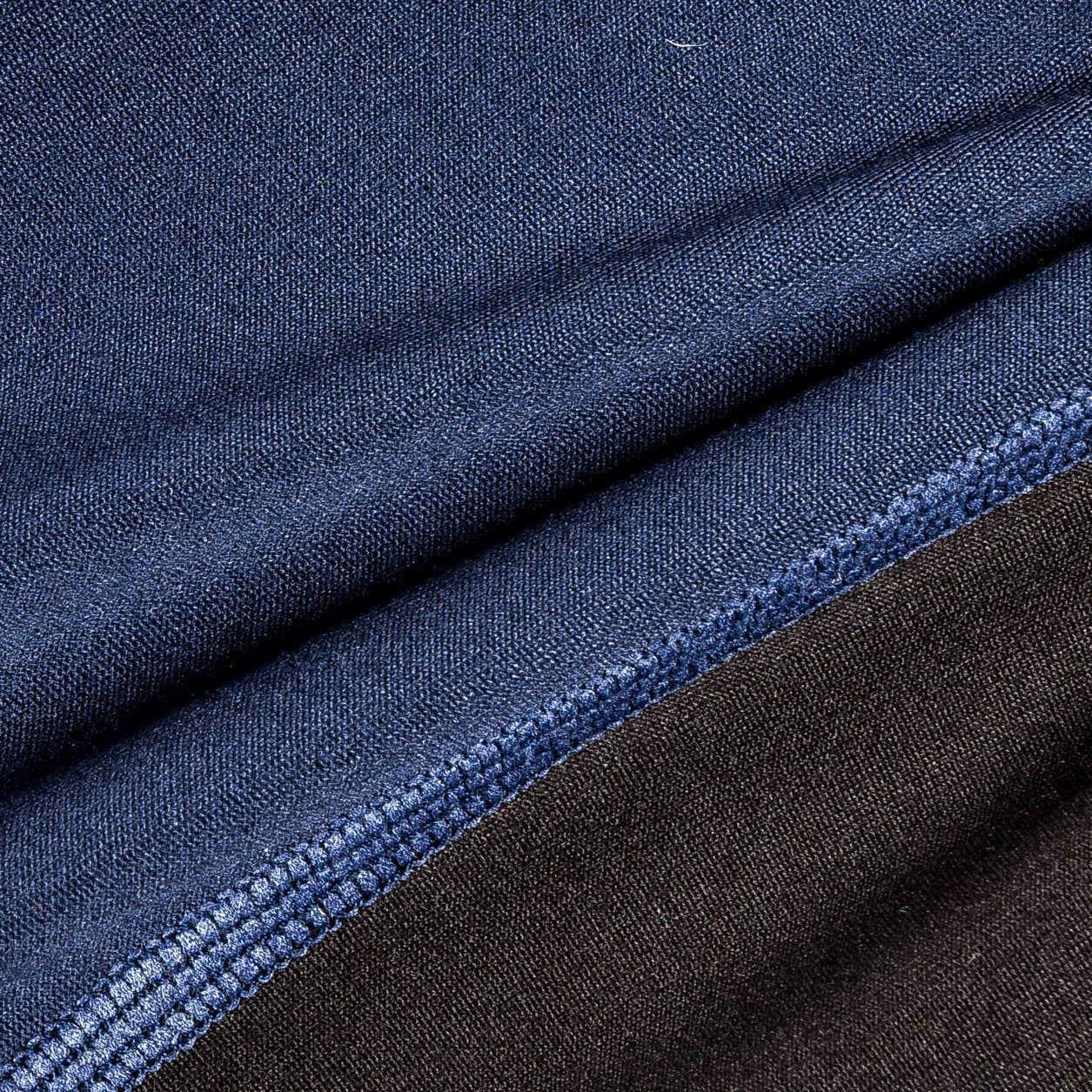 Close-up of blue and black fabric with a visible seam