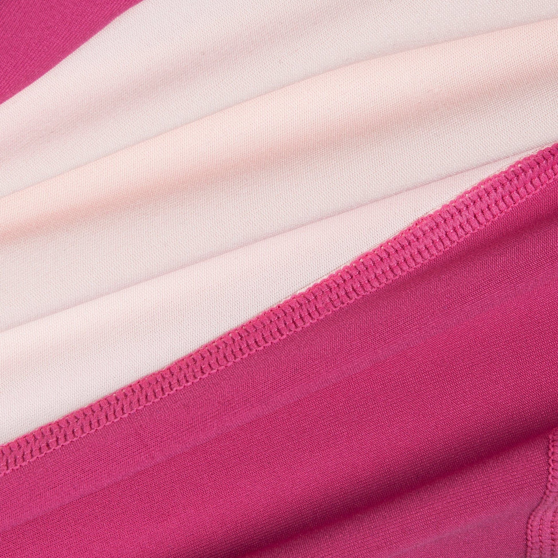 Close-up of pink and white striped fabric with a focus on texture and pattern.